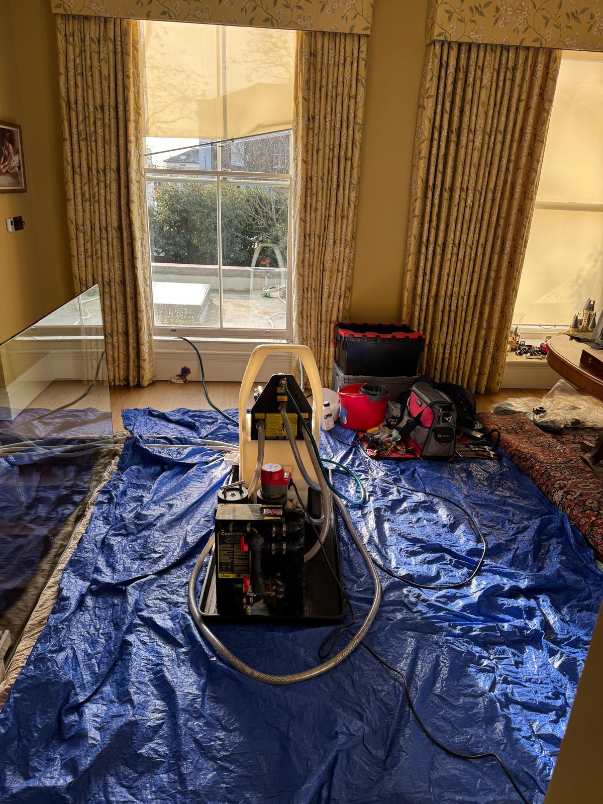 Power flushing machine set up in a London home for a central heating system clean
