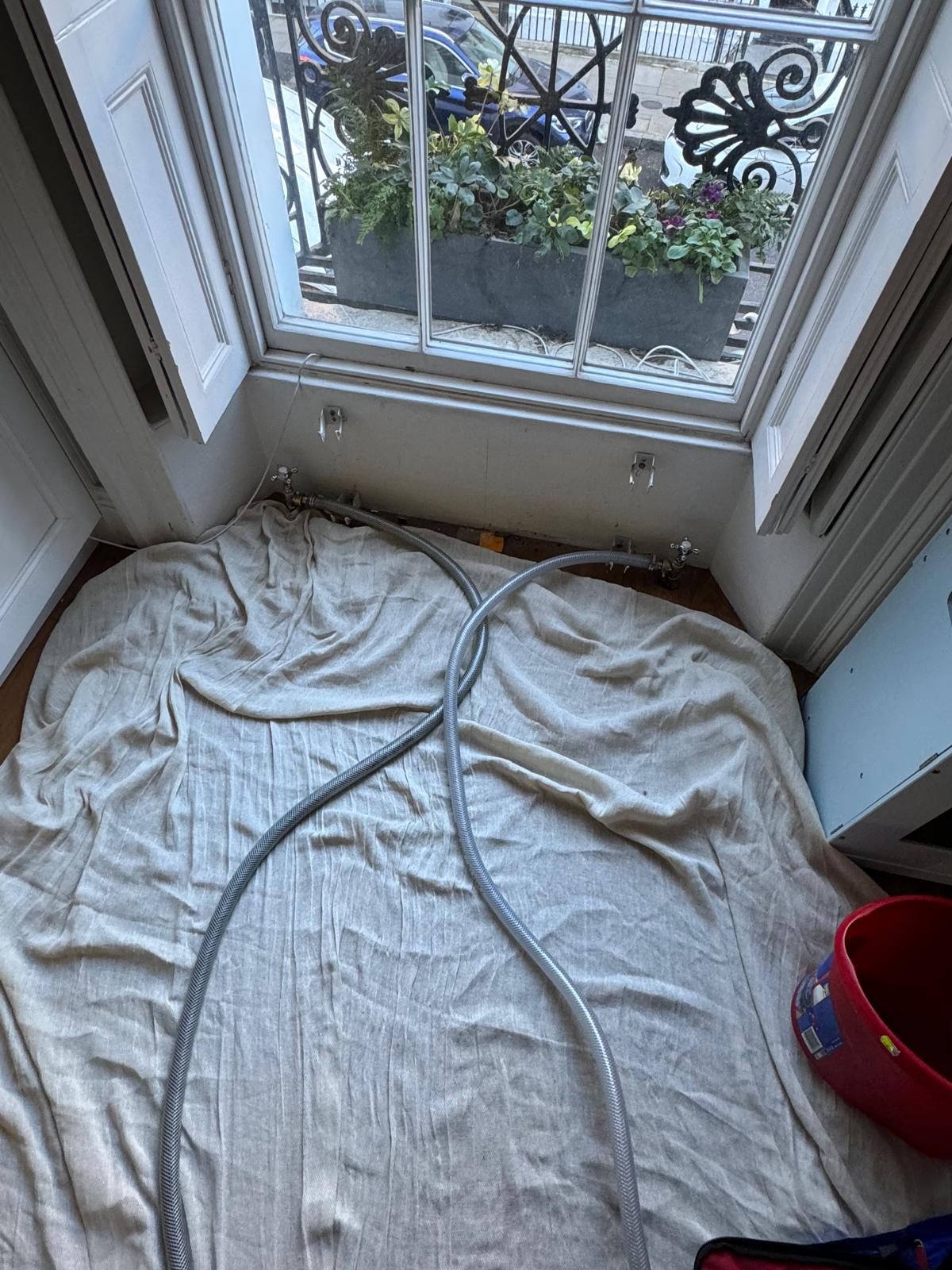 Protected work area set up before power flushing in a London home